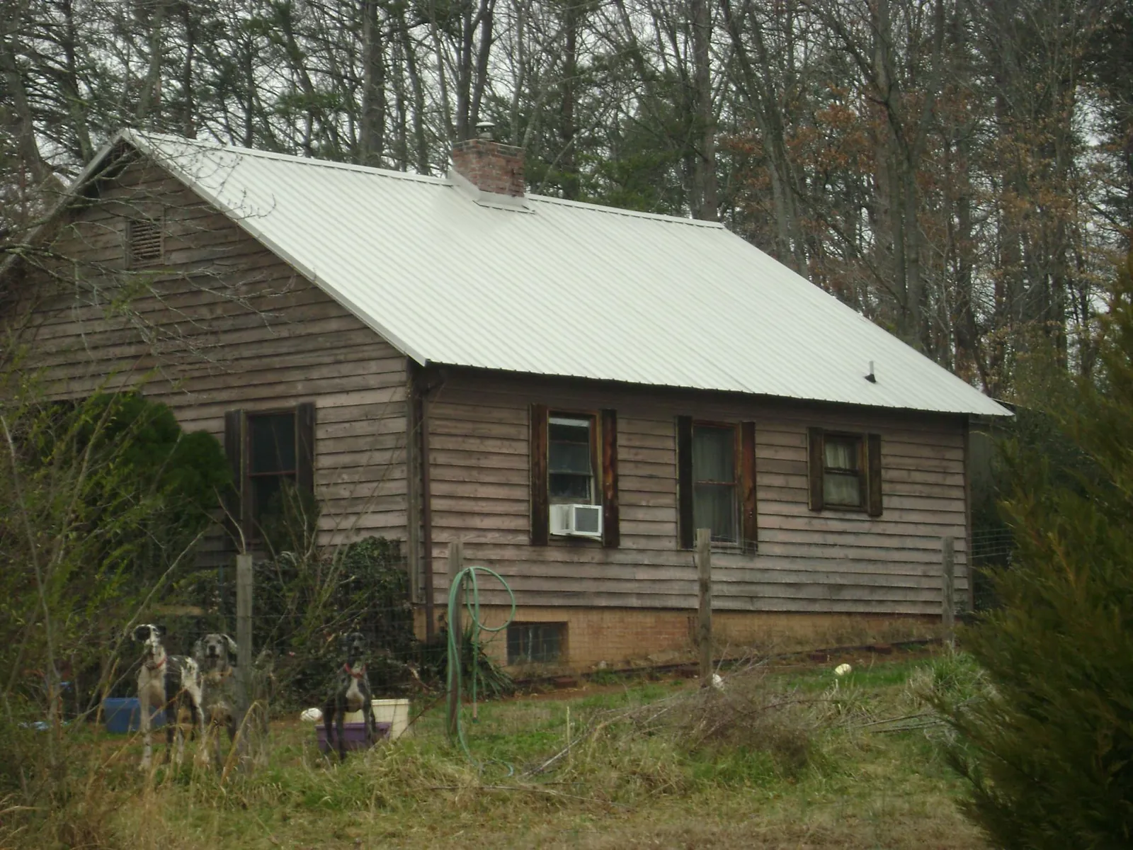 White metal roof on an old wood sided farmhouse, from a Metal Roof Installation job in Perry Hall